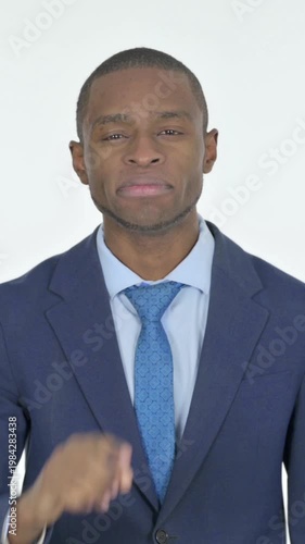 African Businessman with Finger on Lips Asking for Silence on White Background, Vertical Video