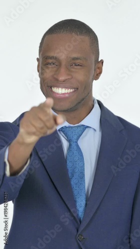 African Businessman Pointing at the Camera on White Background, Vertical Video