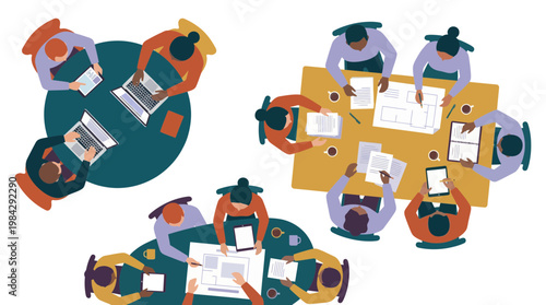 Top view of diverse business executives and project managers collaborating around office tables with laptops, concept for corporate teamwork, strategic planning and workshop management