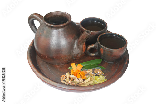 Traditional Indonesian Wedang Uwuh Herbal Tea with Clay Teapot and Cups