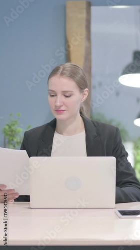 Wallpaper Mural Businesswoman Working on Laptop and Documents, Vertical Video Torontodigital.ca