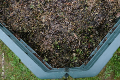 Close-up of a home composting process with organic kitchen leftovers for garden fertilizer. Zero waste and sustainable lifestyle concept.