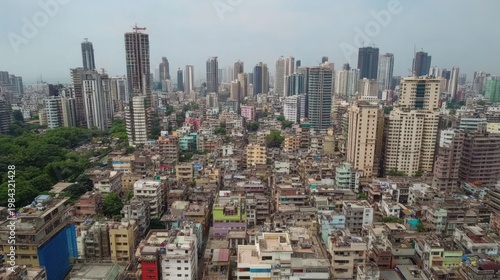 Overlooking dense city skyline with varied buildings, featuring high-rises and residential areas