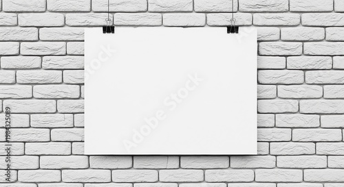 A blank white poster hangs on a white brick wall with black clips. Empty canvas perfect for displaying custom text, graphics, artwork, announcements, or promotional materials.