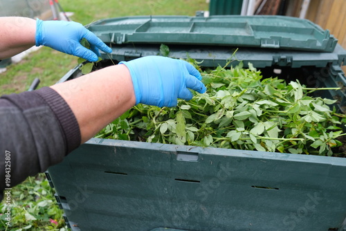 Close-up of a home composting process with organic kitchen leftovers for garden fertilizer. Zero waste and sustainable lifestyle concept.