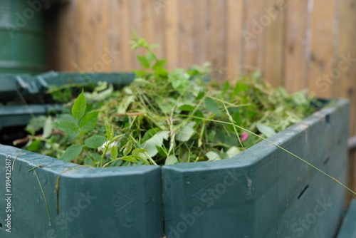 Close-up of a home composting process with organic kitchen leftovers for garden fertilizer. Zero waste and sustainable lifestyle concept.
