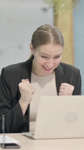 Wallpaper Mural Businesswoman Celebrating Online Success on Laptop in Office, Vertical Video Torontodigital.ca