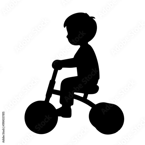 silhouette of a child riding a tricycle