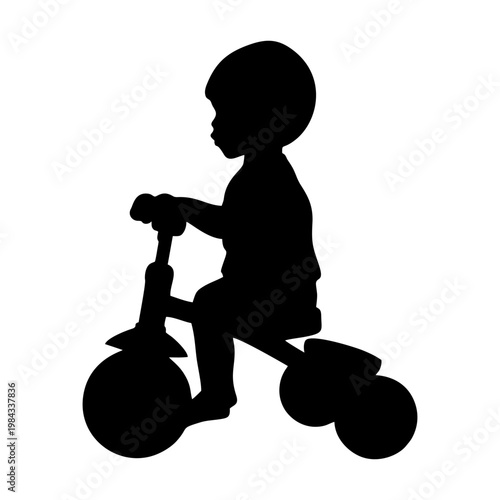silhouette of a child riding a tricycle