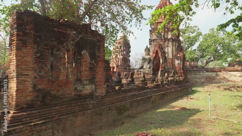 Buddha statue among ruins of the Wat Mahathat in Ayutthaya