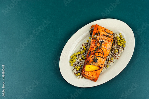 Roasted Salmon Fillet with Quinoa and Green Peas on Plate
