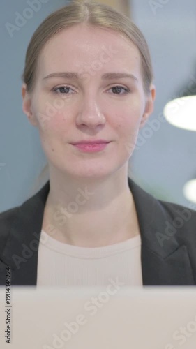 Wallpaper Mural Close Up of Businesswoman Looking at Camera while using Laptop, Vertical Video Torontodigital.ca