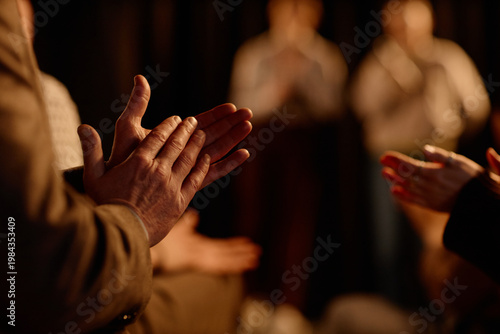 Close up of adult audience clapping during standup performance on stage, signaling live entertainment and public engagement. Useful for event promotion, comedy marketing, ticket sales

