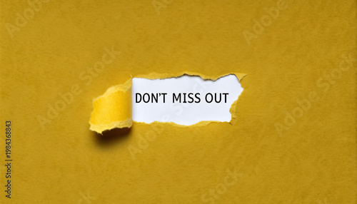 Hole in yellow paper revealing the phrase 