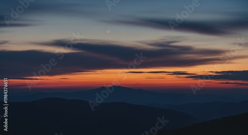 Sunset over the mountains with colorful clouds.