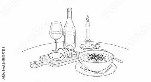 Romantic dinner setting with wine, soup, bread, and a lit candle
