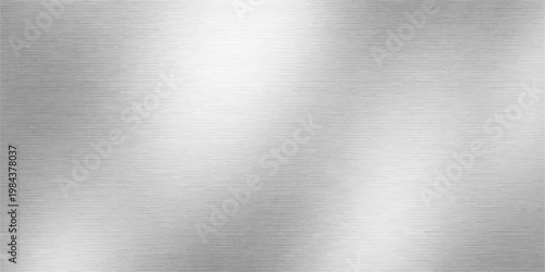Polished silver aluminum and stainless steel plate with a brushed metal texture creates an industrial gray metallic background featuring a shiny reflection on a textured alloy surface pattern