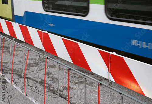 level crossing barriers down with blurred train passing