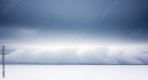 A serene landscape of white clouds and snow under a blue sky