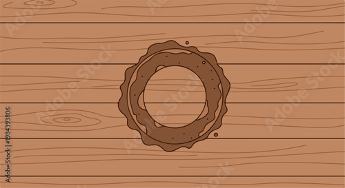 Brown ring with a bumpy edge on a wooden plank surface