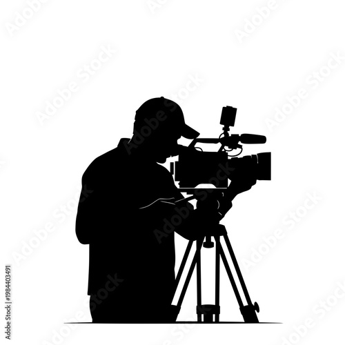 Silhouette of a Professional Videographer Filming with Movie Camera
