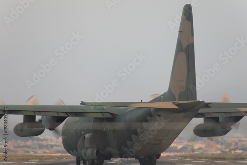 Foto Military C-130 Hercules transport aircraft taxiing on runway