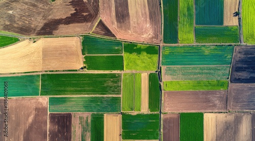 Aerial view of patchwork farmland, green and brown agricultural fields