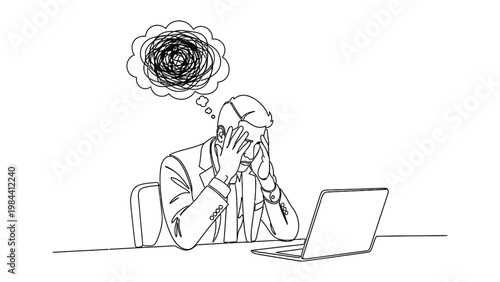 Businessman stressed at his desk with laptop.