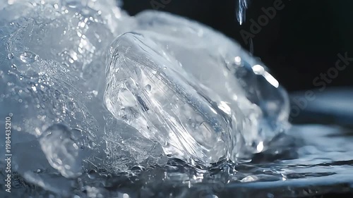 Wallpaper Mural Water droplets fall on melting ice cube on dark surface Torontodigital.ca