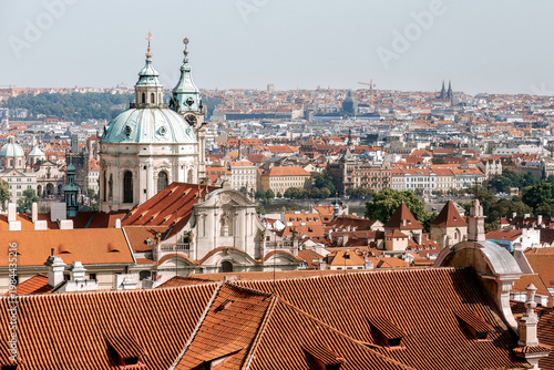 Prague old town cityscape with red roofs and St. Nicholas Church. Czech Republic