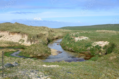 Tidal Waters Winding Around Dunes and Machair In Scotland