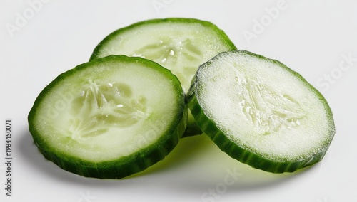 Sliced green vegetable rounds with seeds, fresh and healthy, against a white background