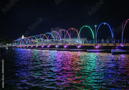 Bild auf Leinwand Night View of Colorfully Illuminated Queen Emma Bridge