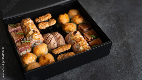 Assorted sushi set in black delivery box, gourmet seafood meal, premium takeout service, commercial food photography, Japanese restaurant promotion, menu