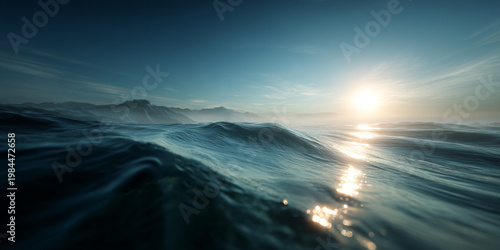 Dramatic Calm Ocean Waves with Sunlight Reflection and Misty Mountains Background