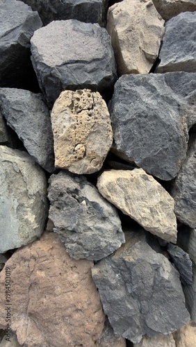 Volcanic stone wall texture background, natural basalt rocks pattern, Tenerife coastal construction