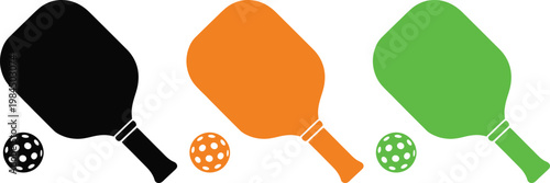 Three paddleball rackets and balls in contrasting colors ready for play