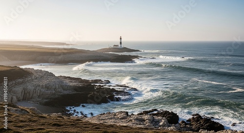 Lighthouse on rocky coastline by ocean.