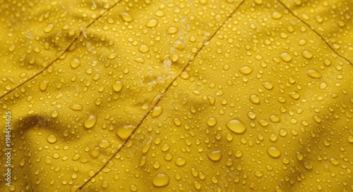 Yellow Fabric with Water Droplets - Close-up View.