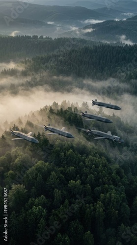 Military fighter jets flying in formation over misty forest at dawn.