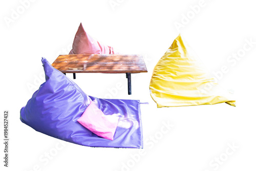 Colorful bean bag seating arrangement soft cushions wooden table isolated on cutout PNG or transparent background. Modern lounge furniture representing comfort relaxation casual cafe. Interior design.