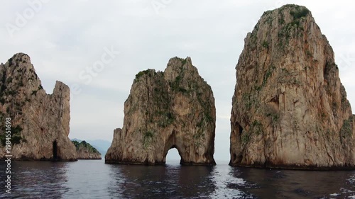 Sailing past the majestic Faraglioni rocks of Capri, Italy