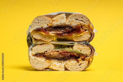 Breakfast bagel sandwich with egg bacon and lettuce
