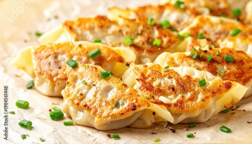 Golden Pan-Fried Pork Dumplings with Savory Chive Garnish, Perfectly Seared and Appetizing.