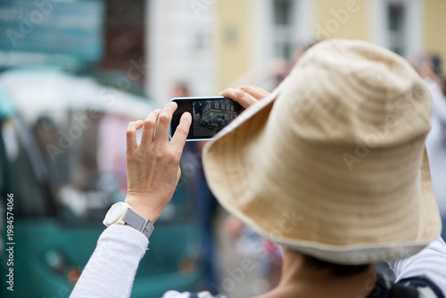 Woman Taking Photo With Smartphone In City Street