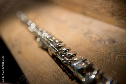 Silver Flute  On Wooden Surface Closeup