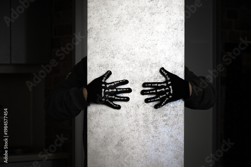 Anonymous Person With Skeleton Gloves Holding Bright Panel