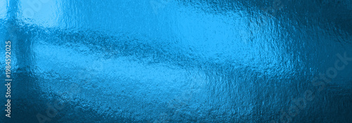 Abstract blue reflection background on a glossy surface with cyan light and t...