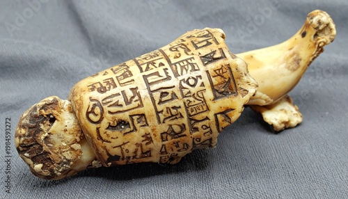 Ancient bone fragment intricately inscribed with Proto-Sinaitic script, a rare archaeological artifact revealing early writing systems.
