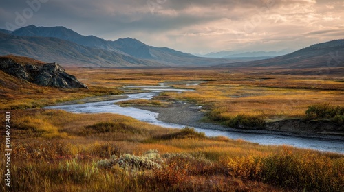 Alaskan North Slope autumn scenery: expansive tundra, meandering river, and an industrial pipeline